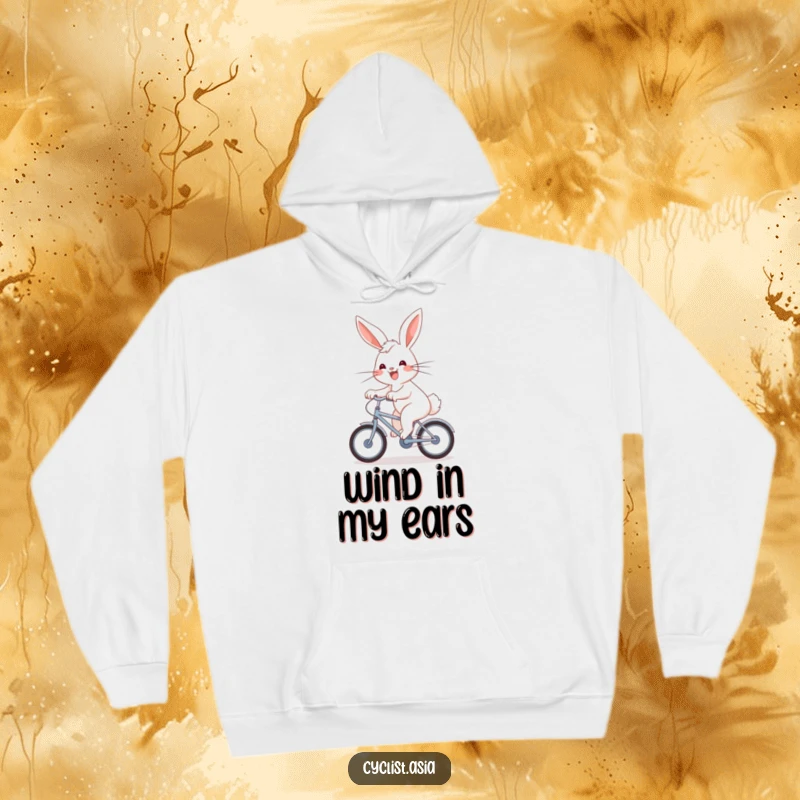Funny Hoodie: An energetic bunny with a joyful grin pedals a small bicycle, wind in its fur.