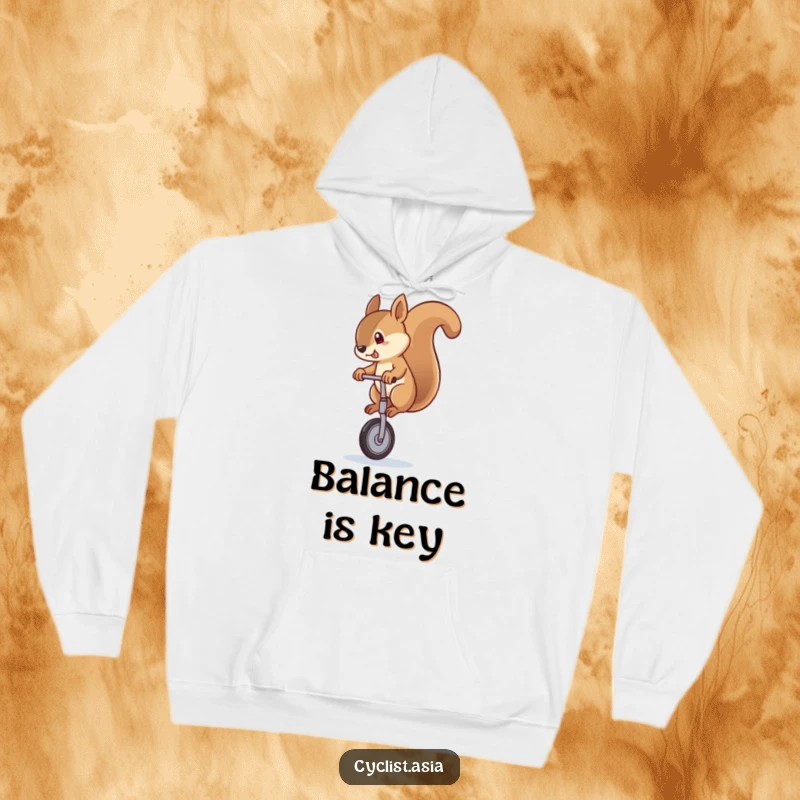 Funny squirrel hoodie showing a cute squirrel wobbling while riding a unicycle, offering warmth and a hearty laugh.